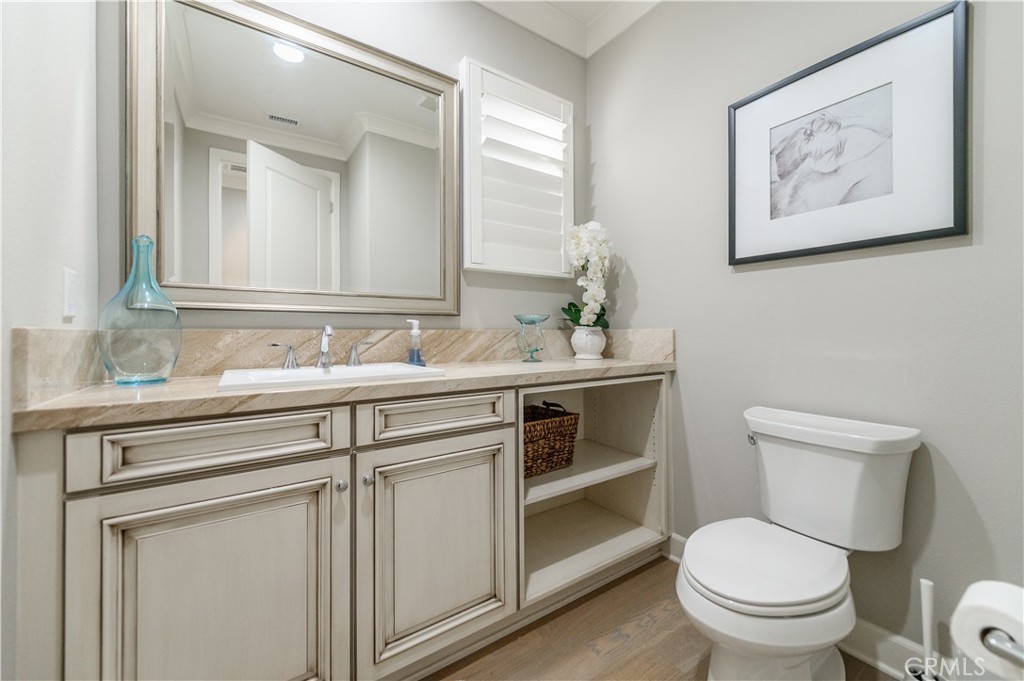 126 Long Fence Irvine, CA 92602 - Photo 29 of 61 a bathroom with a toilet sink and mirror