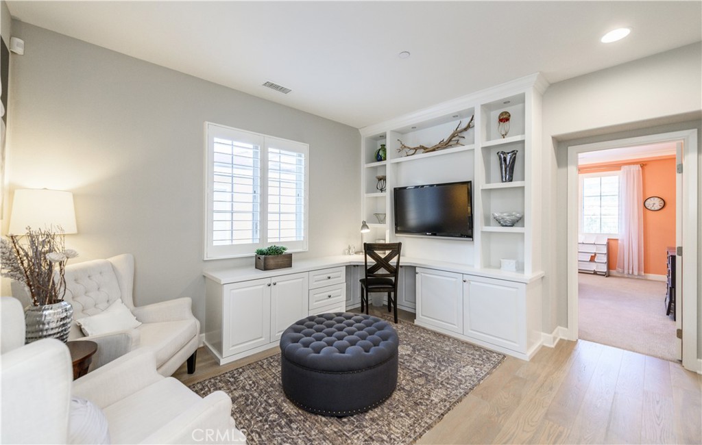 126 Long Fence Irvine, CA 92602 - Photo 33 of 61 a living room with furniture a flat screen tv and a large window