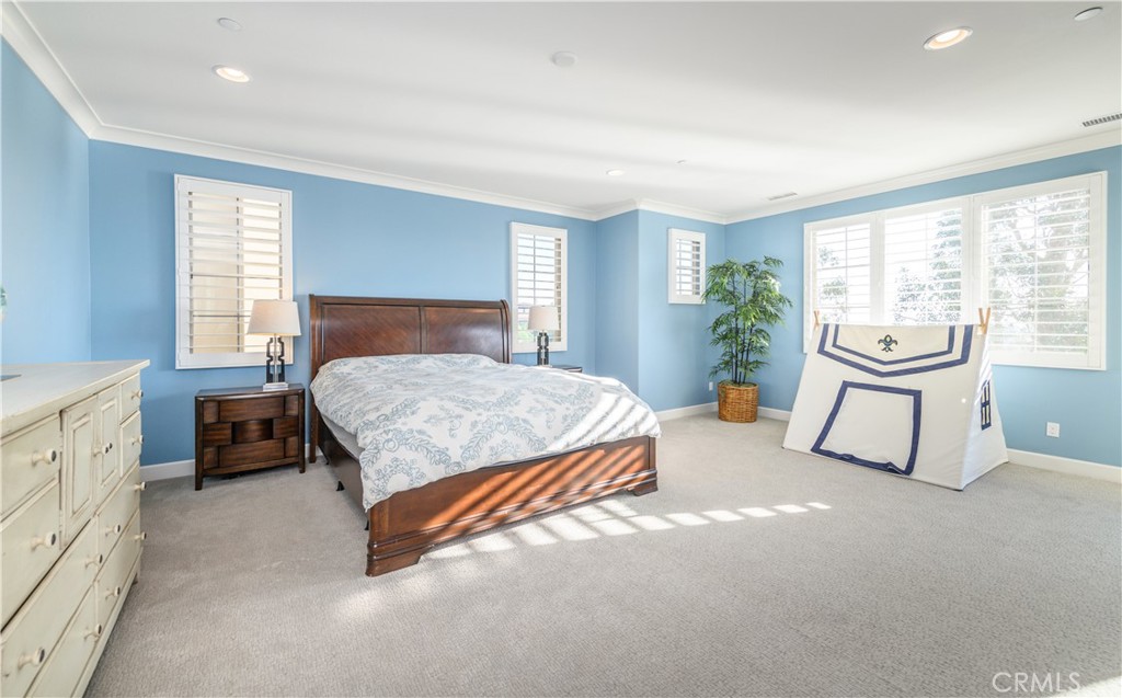 126 Long Fence Irvine, CA 92602 - Photo 35 of 61 a bedroom with a bed and a couch