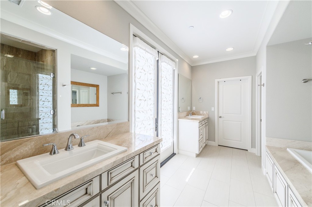126 Long Fence Irvine, CA 92602 - Photo 40 of 61 a bathroom with a granite countertop sink mirror and a bathtub