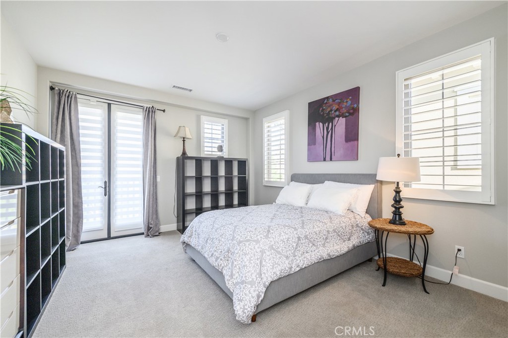 126 Long Fence Irvine, CA 92602 - Photo 46 of 61 a bedroom with a bed closet and a window