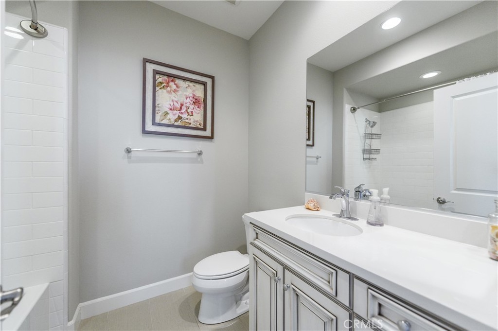 126 Long Fence Irvine, CA 92602 - Photo 47 of 61 a bathroom with a toilet sink and mirror