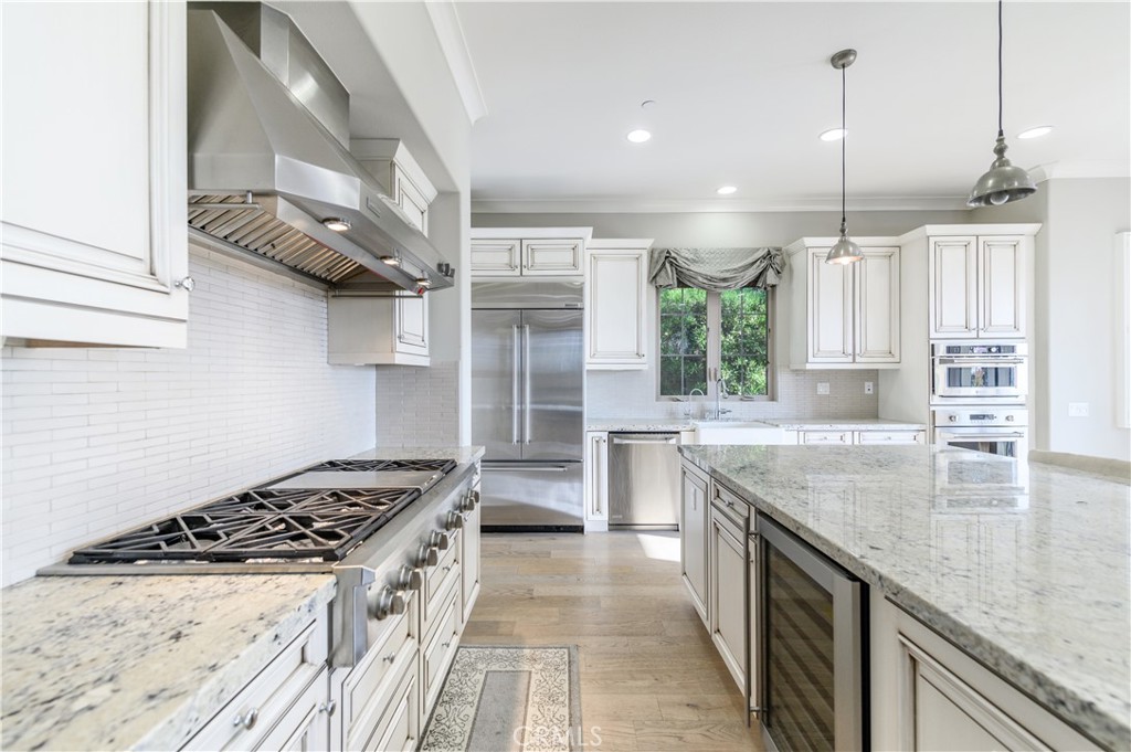 126 Long Fence Irvine, CA 92602 - Photo 5 of 61 a kitchen with stainless steel appliances granite countertop a stove and a sink