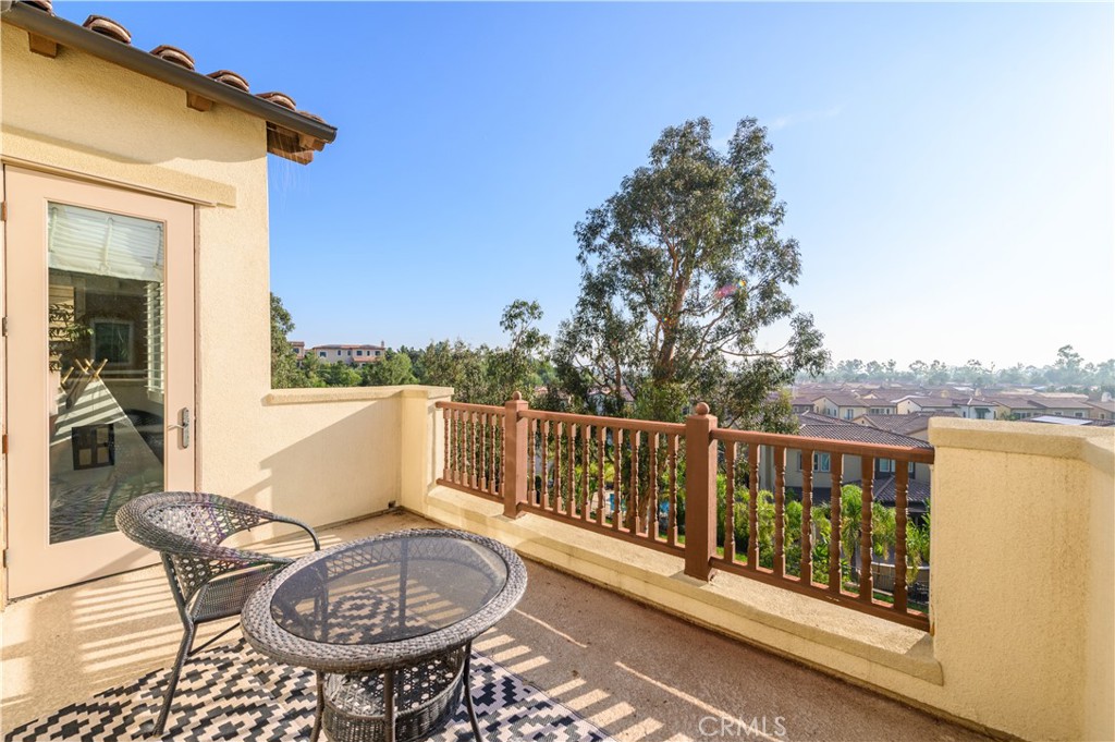 126 Long Fence Irvine, CA 92602 - Photo 53 of 61 a balcony with wooden floor table and chairs