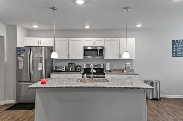 a kitchen that has a lot of cabinets in it