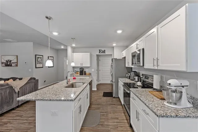 a kitchen with sink stove and cabinets