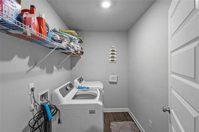 a bedroom with a bed chandelier and a window