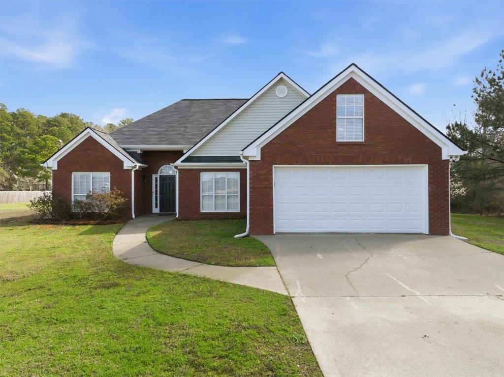 493 Youth Jersey Road Covington, GA 30014 - Photo 1 of 52 a front view of a house with a yard and garage