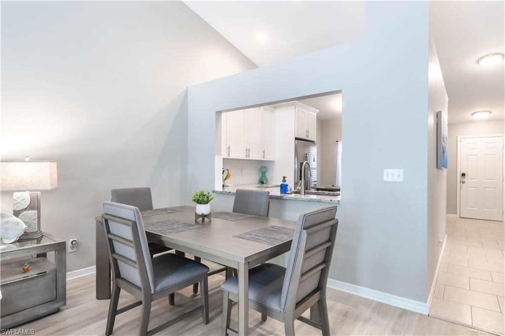 480 St Andrews Boulevard, Unit 14 Naples, FL 34113 - Photo 11 of 24 a view of a dining room with furniture and window