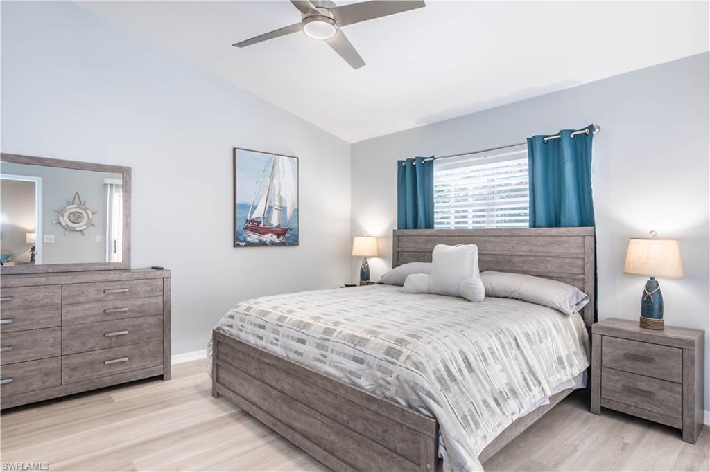 480 St Andrews Boulevard, Unit 14 Naples, FL 34113 - Photo 12 of 24 a bedroom with a bed and a dresser