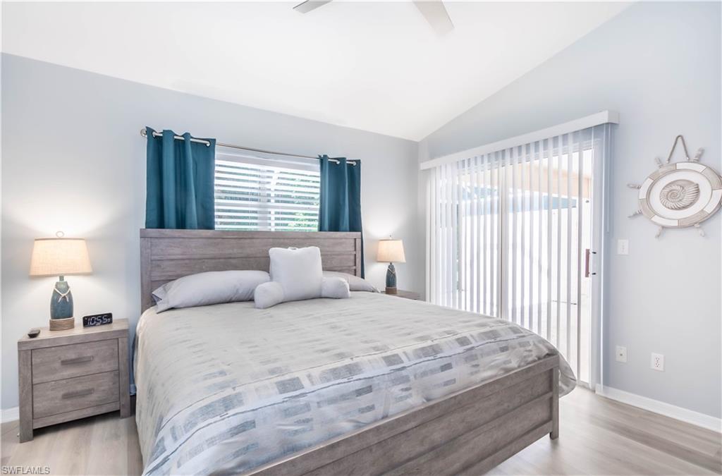 480 St Andrews Boulevard, Unit 14 Naples, FL 34113 - Photo 13 of 24 a bedroom with a bed and a night stand