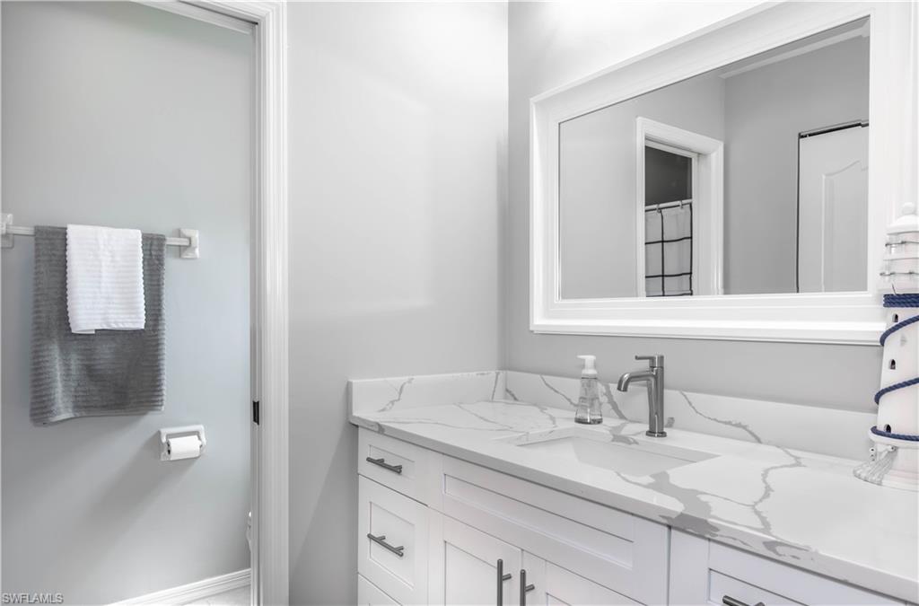 480 St Andrews Boulevard, Unit 14 Naples, FL 34113 - Photo 16 of 24 a bathroom with a sink and a mirror
