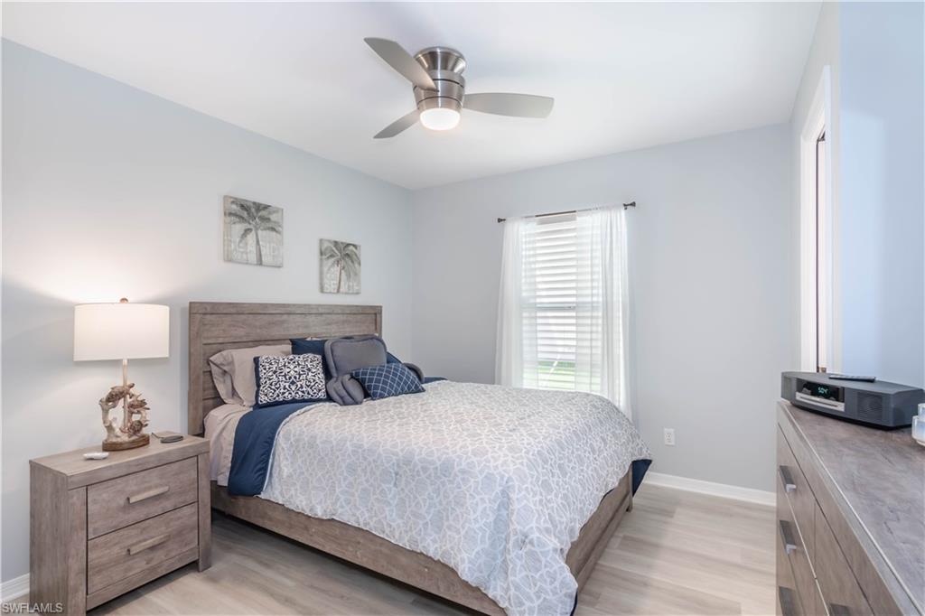 480 St Andrews Boulevard, Unit 14 Naples, FL 34113 - Photo 18 of 24 a bedroom with a bed and a night stand