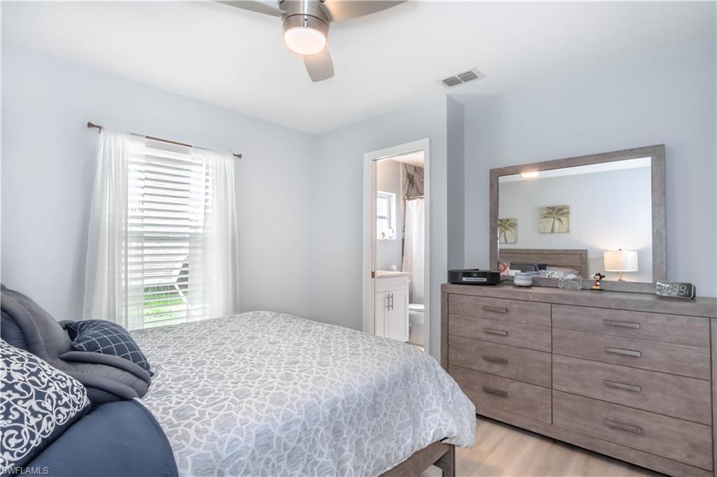 480 St Andrews Boulevard, Unit 14 Naples, FL 34113 - Photo 19 of 24 a bedroom with a bed and a dresser
