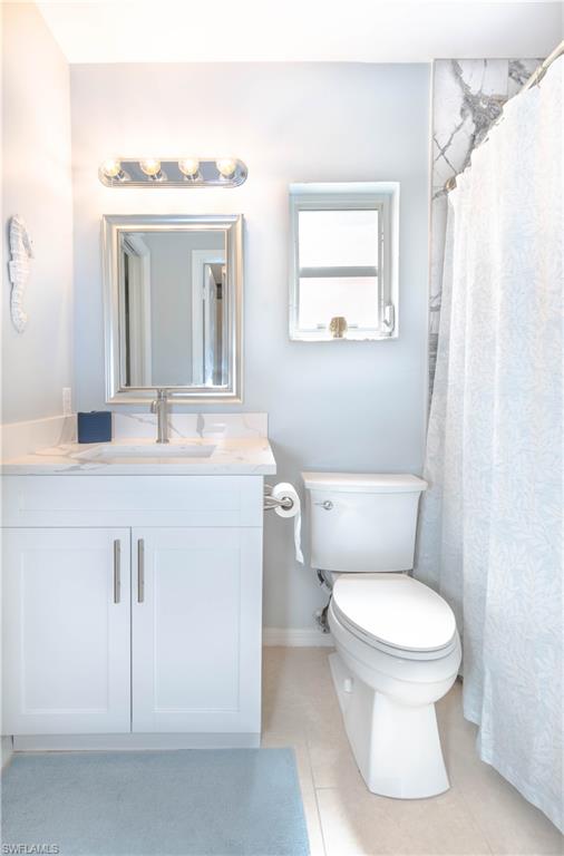 480 St Andrews Boulevard, Unit 14 Naples, FL 34113 - Photo 20 of 24 a bathroom with a granite countertop toilet sink and mirror