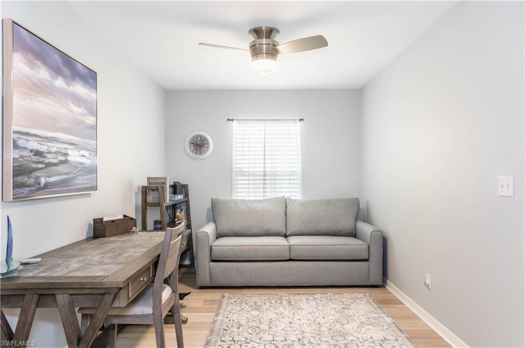 480 St Andrews Boulevard, Unit 14 Naples, FL 34113 - Photo 21 of 24 a living room with furniture and a window