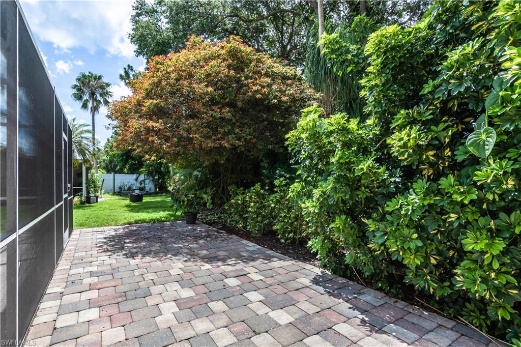 480 St Andrews Boulevard, Unit 14 Naples, FL 34113 - Photo 24 of 24 a view of a yard with plants and a trees