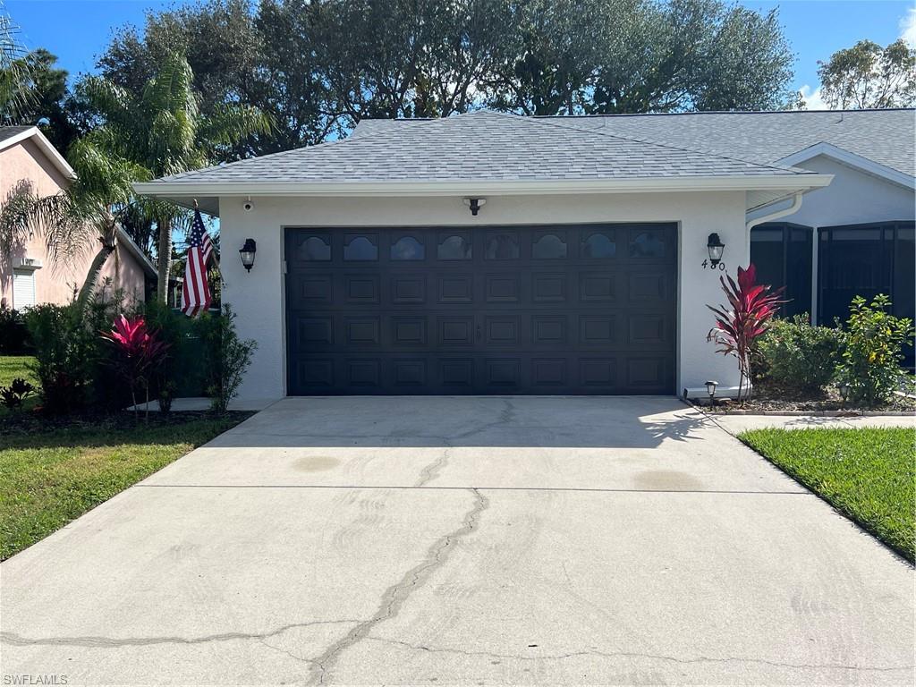 480 St Andrews Boulevard, Unit 14 Naples, FL 34113 - Photo 3 of 24 a front view of house with yard