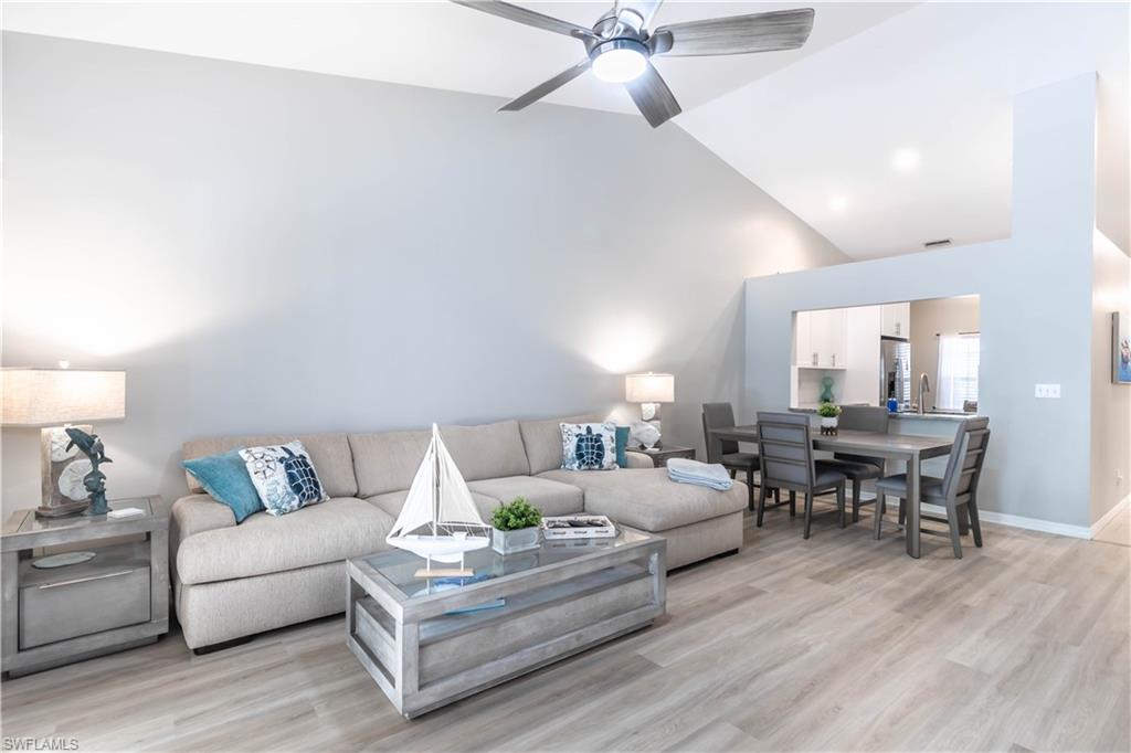 480 St Andrews Boulevard, Unit 14 Naples, FL 34113 - Photo 4 of 24 a living room with furniture and a wooden floor