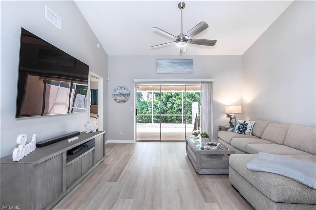 480 St Andrews Boulevard, Unit 14 Naples, FL 34113 - Photo 5 of 24 a living room with furniture and a large window
