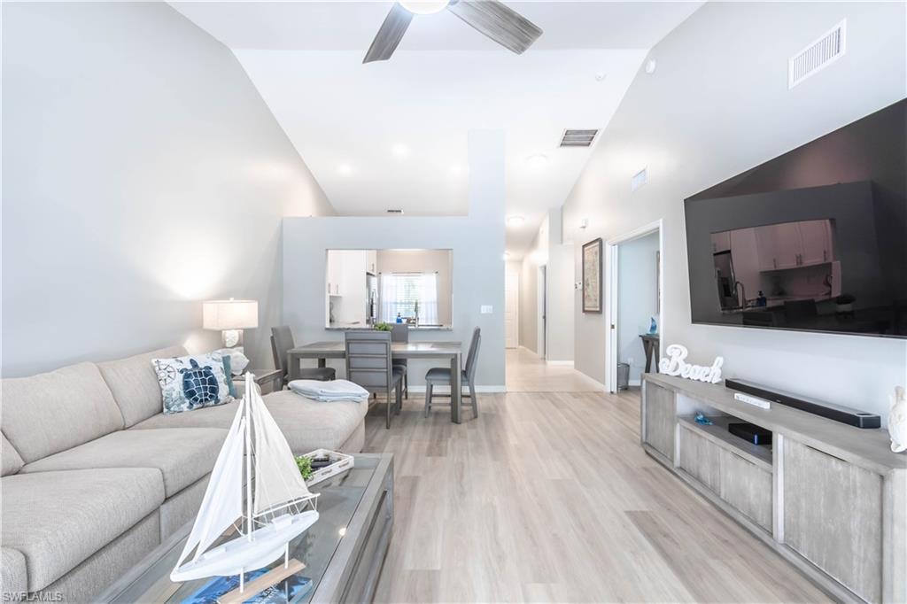 480 St Andrews Boulevard, Unit 14 Naples, FL 34113 - Photo 6 of 24 a living room with furniture and a flat screen tv