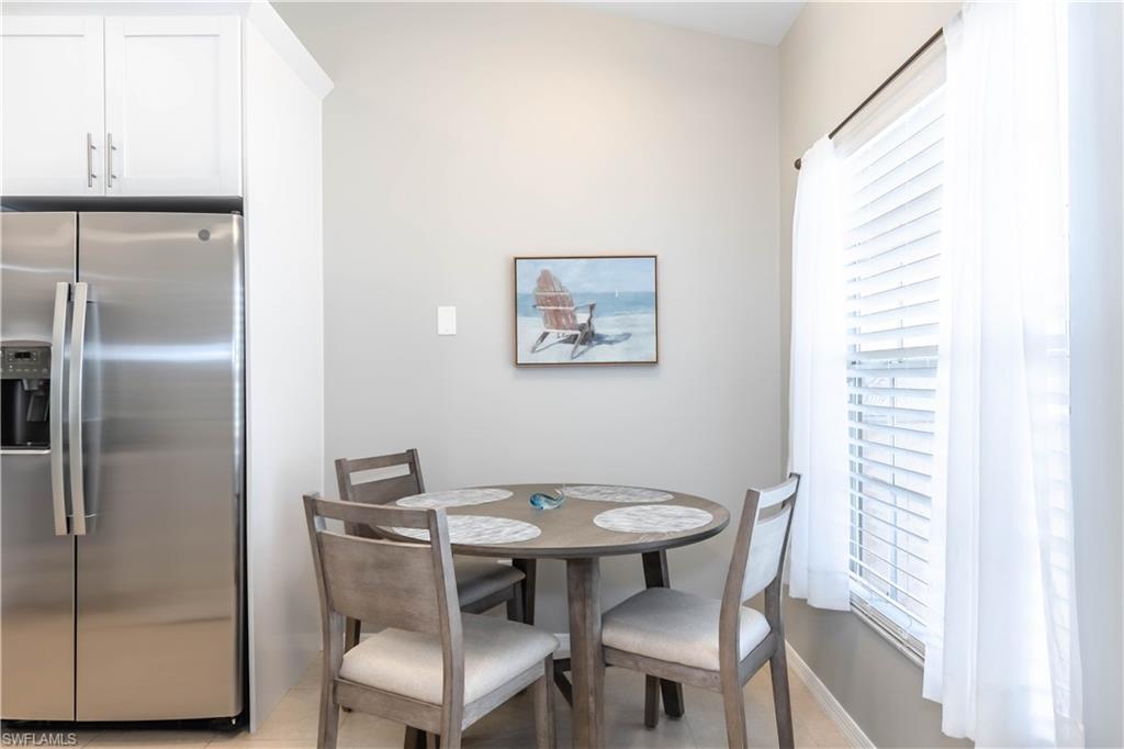 480 St Andrews Boulevard, Unit 14 Naples, FL 34113 - Photo 9 of 24 a view of a dining room with furniture and a window