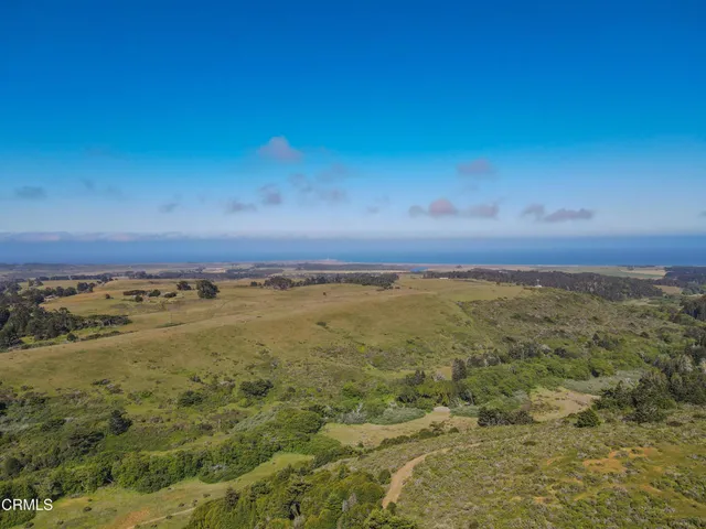 a view of a house with wooden fence