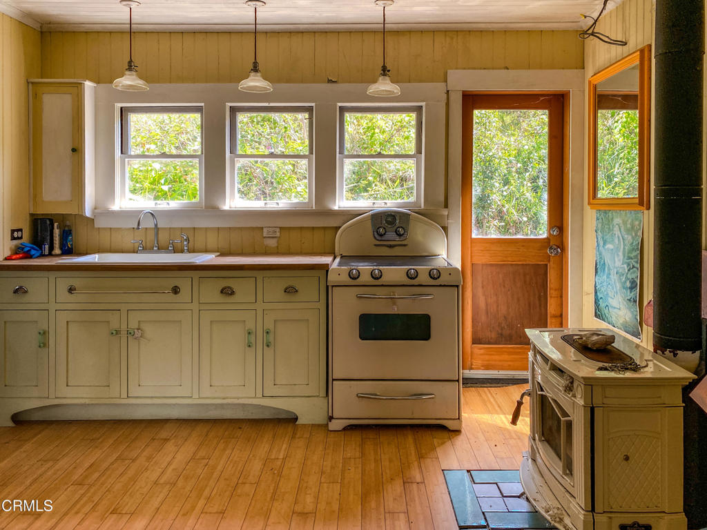 42000 Mountain View Road Manchester, CA 95459 - Photo 28 of 54 a kitchen with a stove a sink and a window