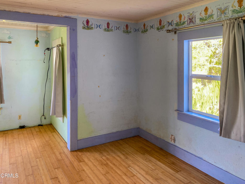 42000 Mountain View Road Manchester, CA 95459 - Photo 30 of 54 a view of a hallway with wooden floor and a window