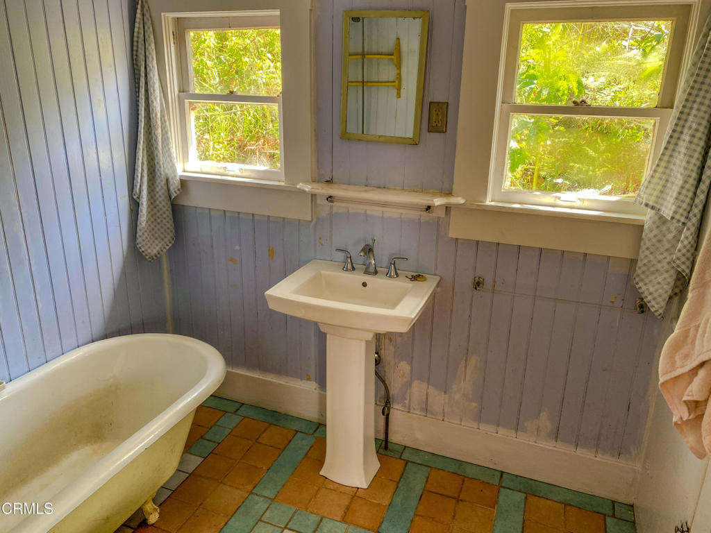 42000 Mountain View Road Manchester, CA 95459 - Photo 36 of 54 a bathroom with a sink a bathtub and window