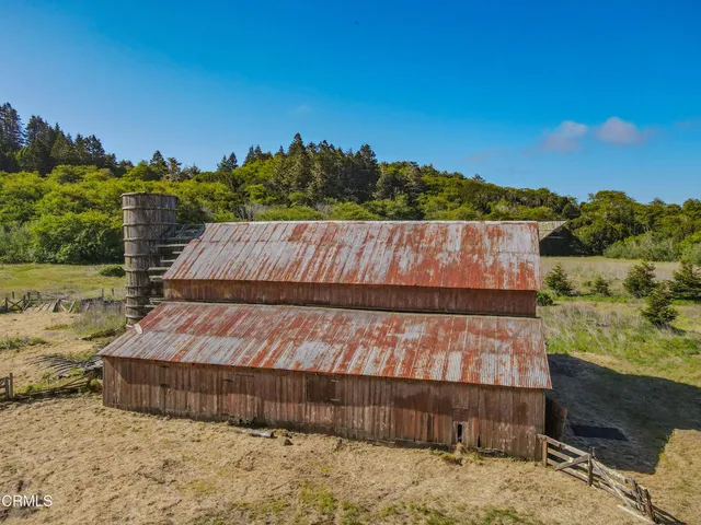 a view of a wooden wall with a yard