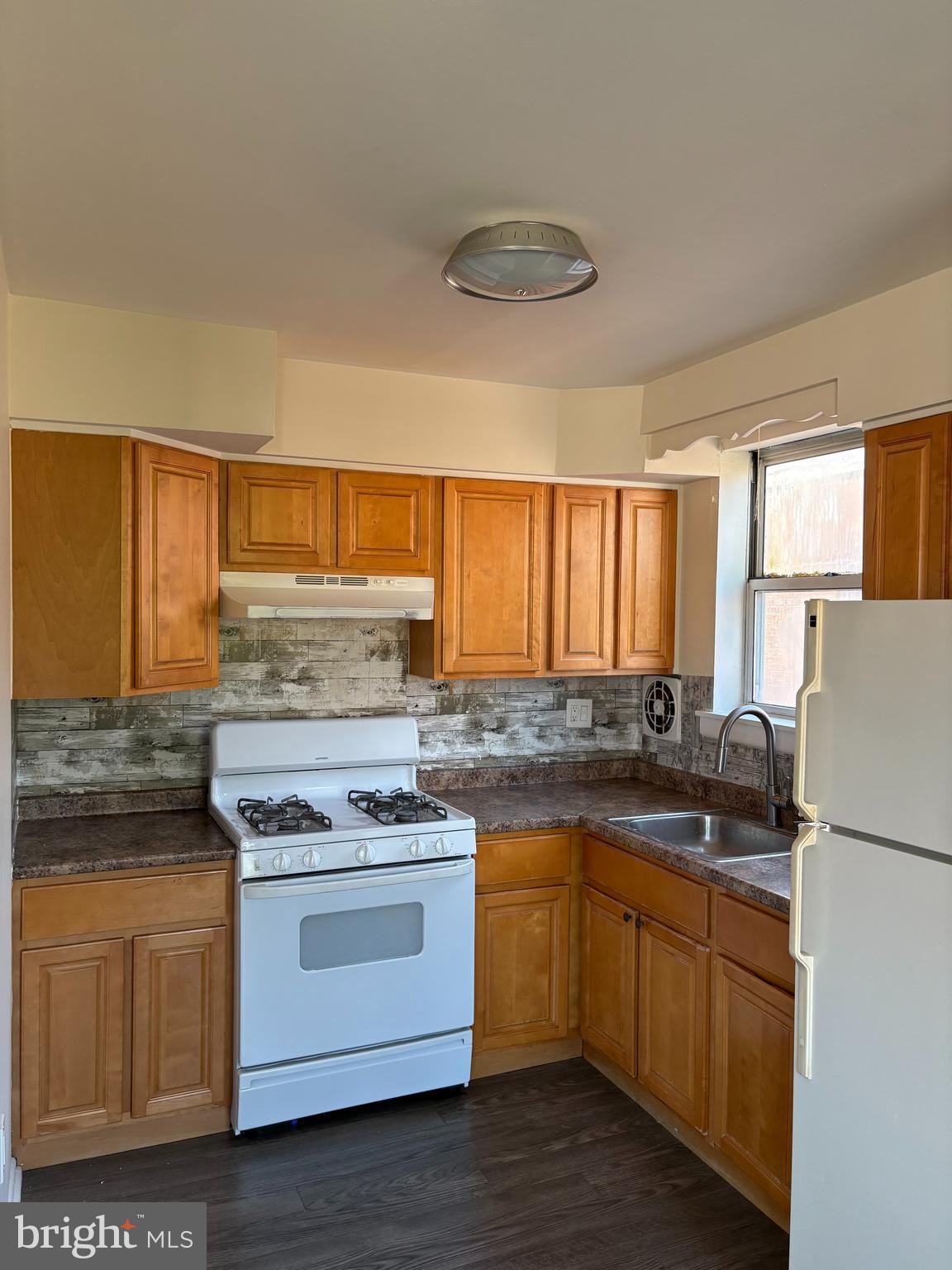 261 Ridgeway Terrace Philadelphia, PA 19116 - Photo 2 of 15 a kitchen with a stove a sink and a refrigerator