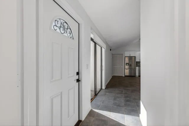 a view of a hallway to rooms