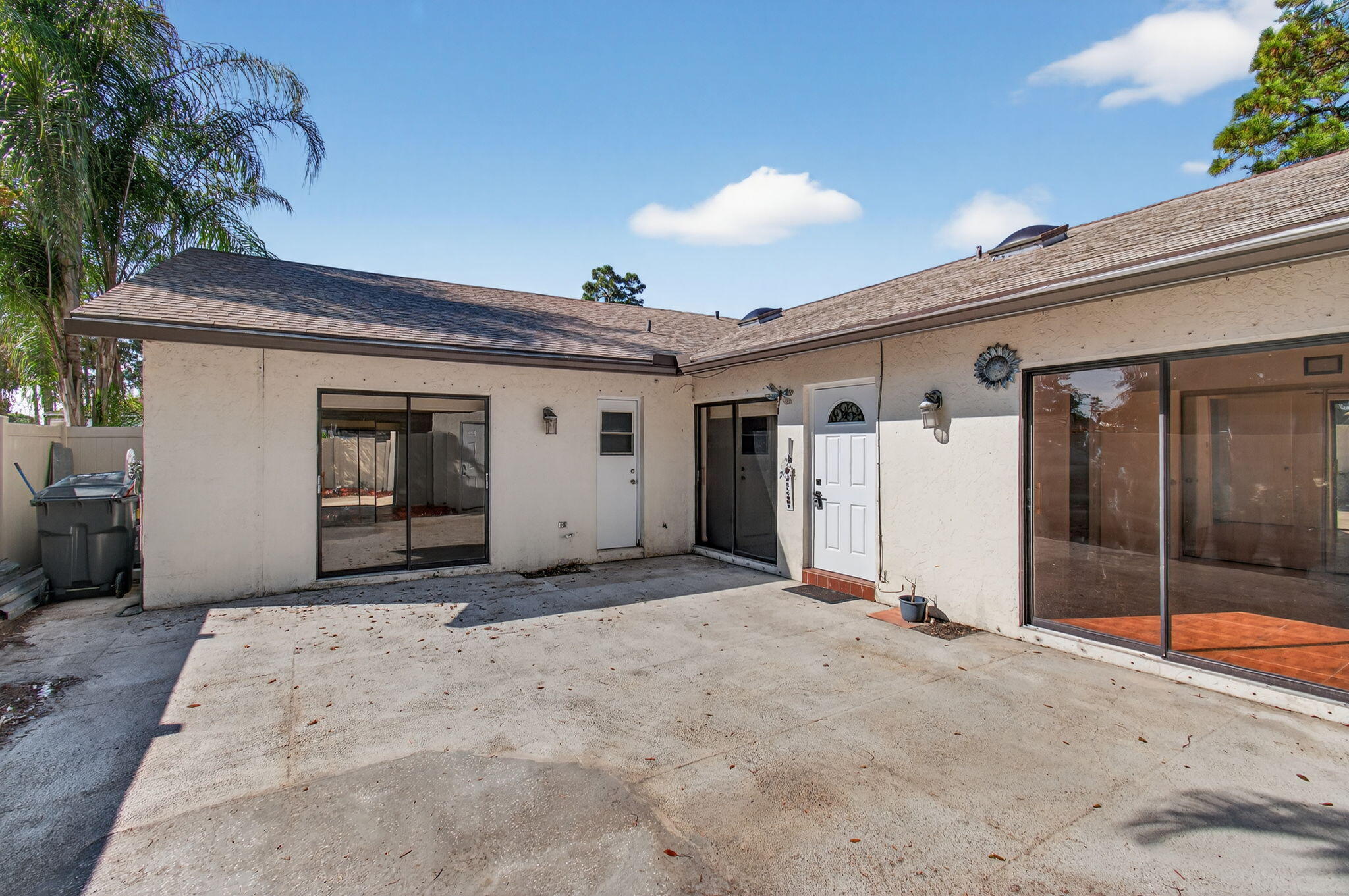 1350 Periwinkle Place Wellington, FL 33414 - Photo 44 of 49 a view of a house with a wooden fence