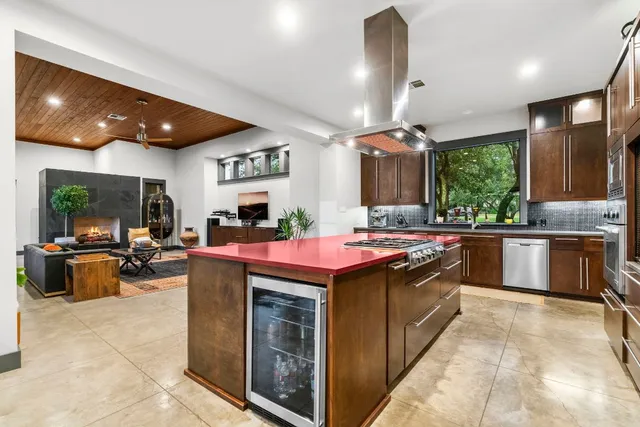 a kitchen with a stove a counter top space furniture and a fireplace