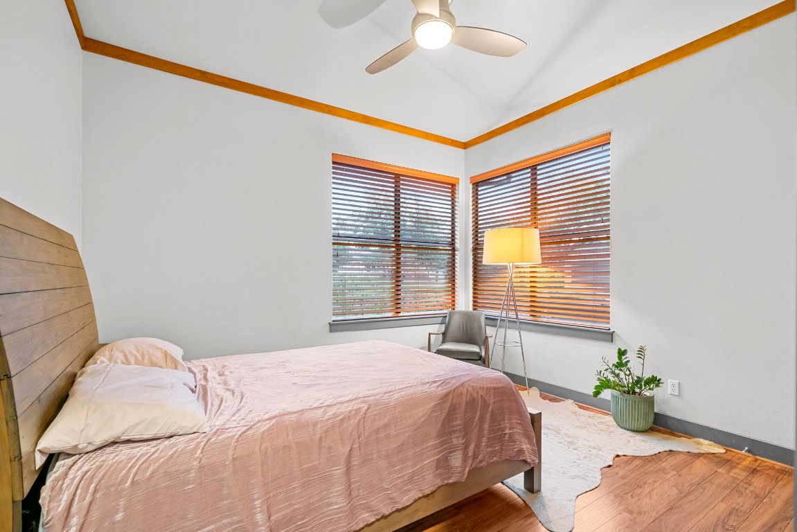 332 Rugged Earth Drive, Unit 1 Austin, TX 78737 - Photo 18 of 32 a bedroom with bed and window
