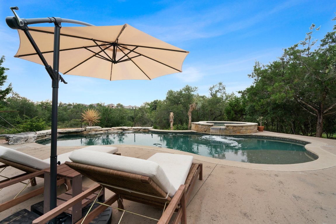 332 Rugged Earth Drive, Unit 1 Austin, TX 78737 - Photo 28 of 32 a view of a balcony with a table and chairs