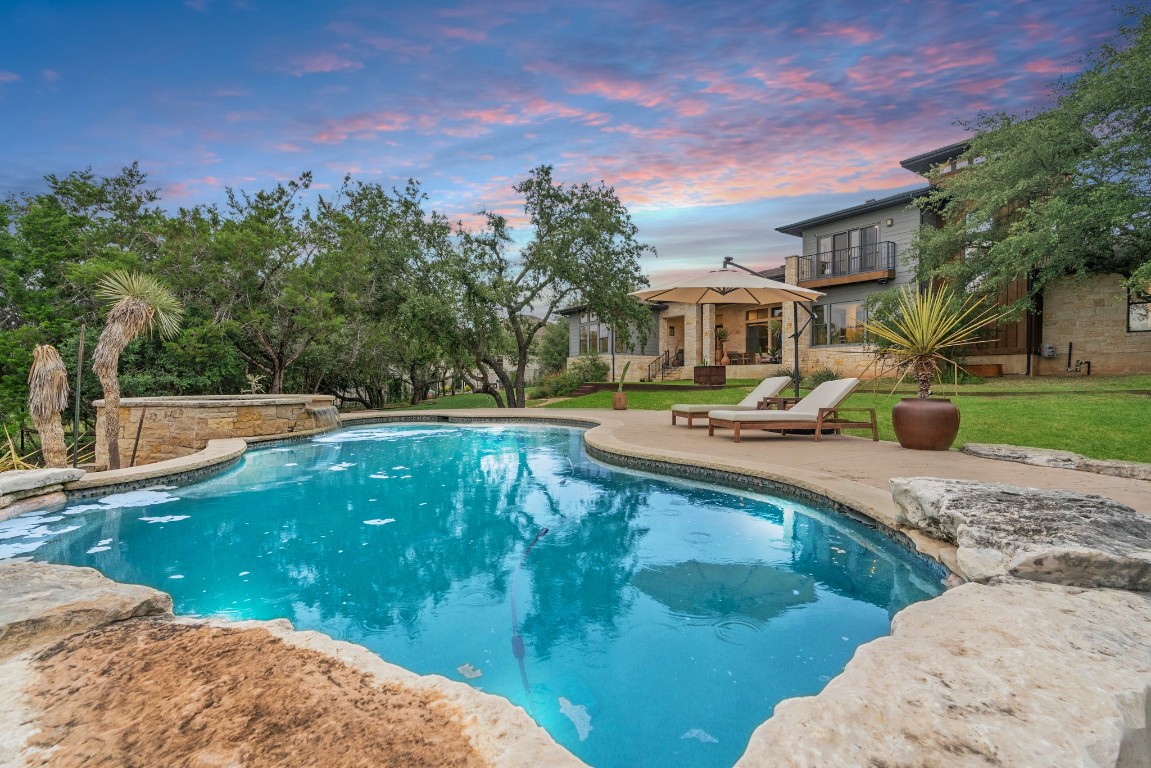 332 Rugged Earth Drive, Unit 1 Austin, TX 78737 - Photo 29 of 32 a view of a swimming pool with a patio