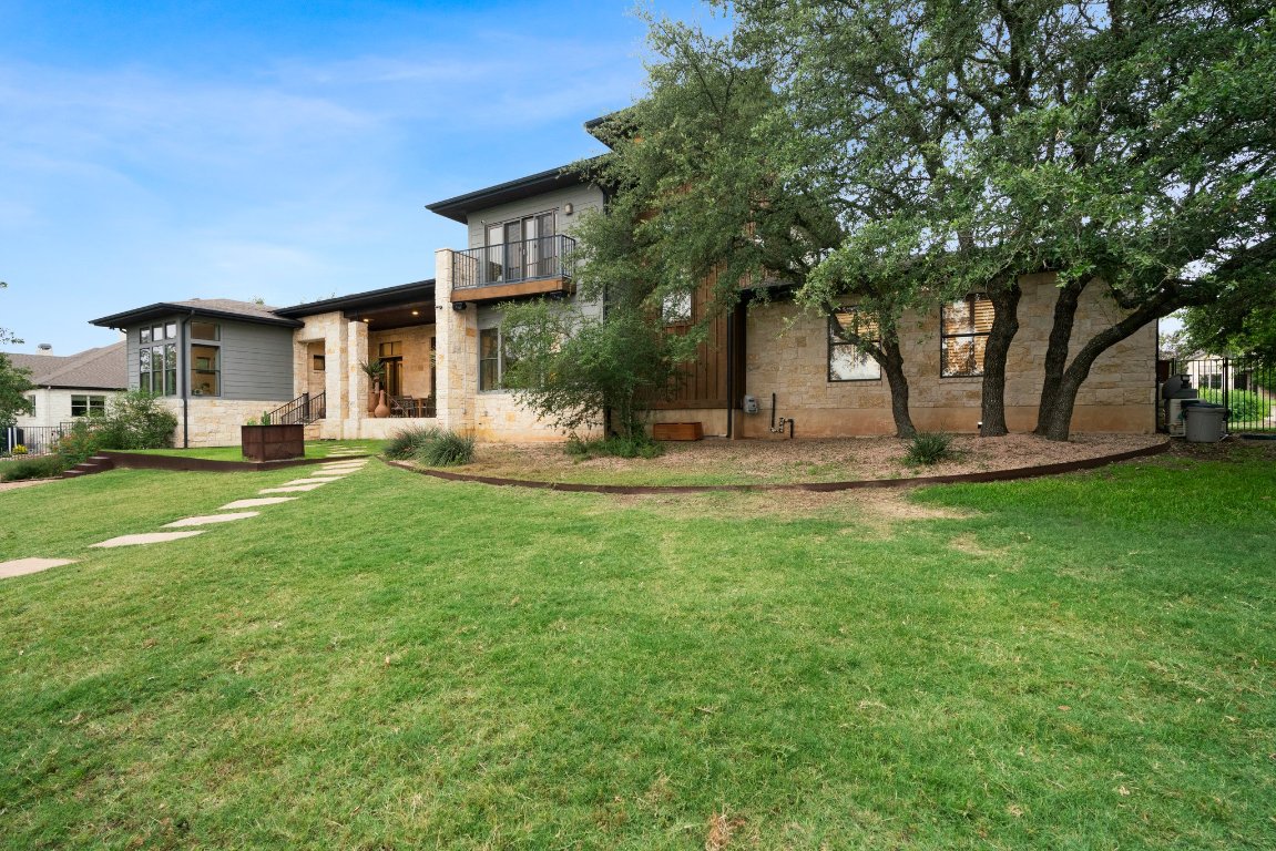 332 Rugged Earth Drive, Unit 1 Austin, TX 78737 - Photo 30 of 32 a view of a house with a yard