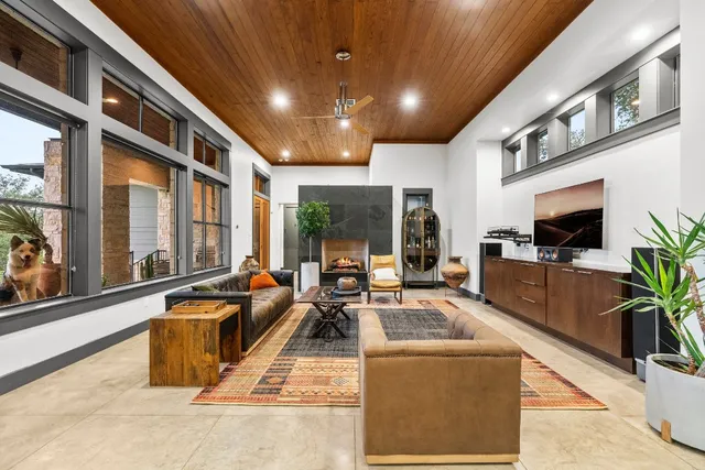 a living room with furniture tv and a potted plant