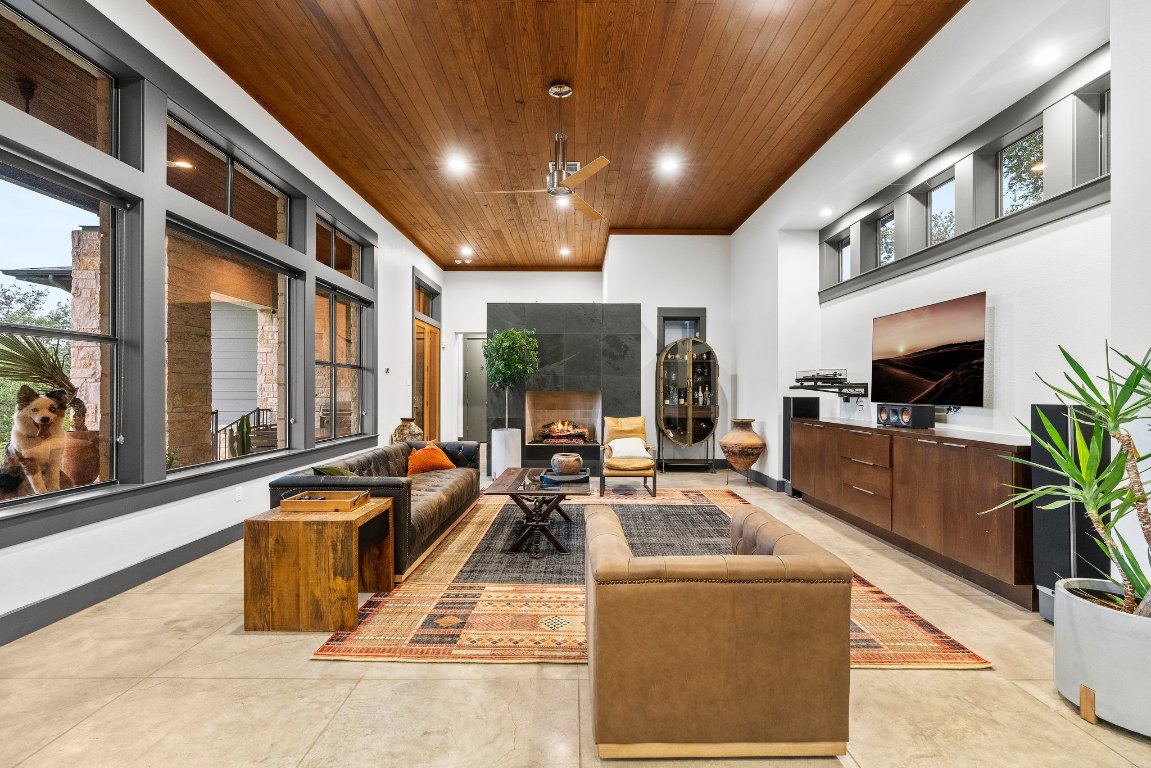 332 Rugged Earth Drive, Unit 1 Austin, TX 78737 - Photo 4 of 32 a living room with furniture tv and a potted plant