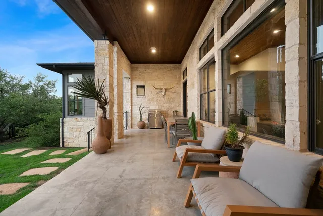 a balcony with furniture and a garden