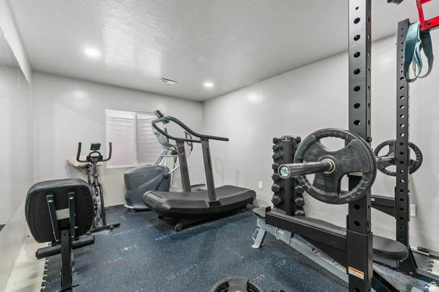 5686 Duke Lane Tooele, UT 84074 - Photo 33 of 38 Exercise area with rubber floors, a textured ceiling, and recessed lighting