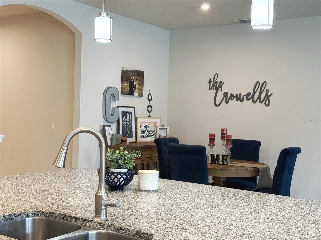 3181 Hill Point Street Minneola, FL 34715 - Photo 16 of 52 a bathroom with a granite countertop sink a mirror and vanity