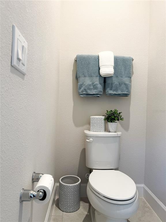 3181 Hill Point Street Minneola, FL 34715 - Photo 26 of 52 a white toilet sitting next to a bathroom sink