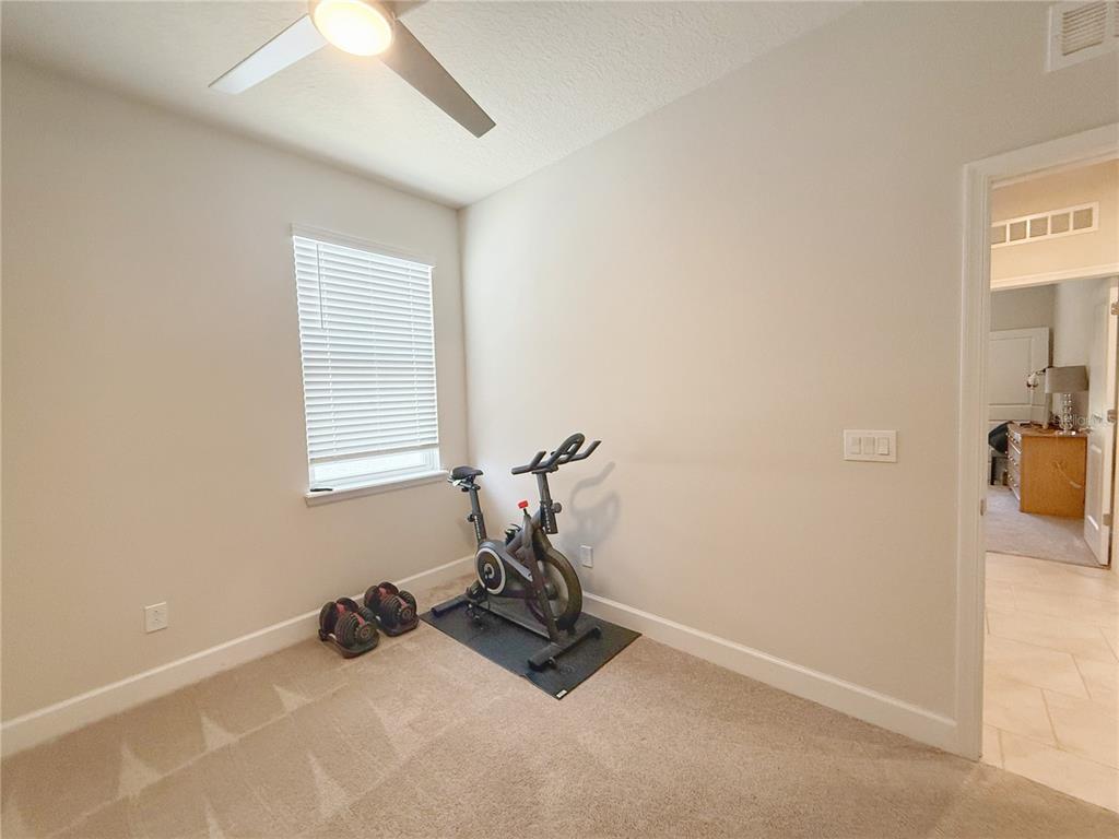 3181 Hill Point Street Minneola, FL 34715 - Photo 32 of 52 a room with gym equipment and a window