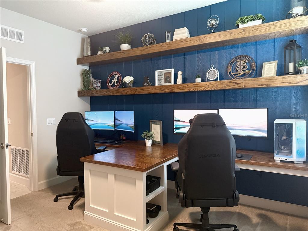 3181 Hill Point Street Minneola, FL 34715 - Photo 38 of 52 a workspace with furniture and window