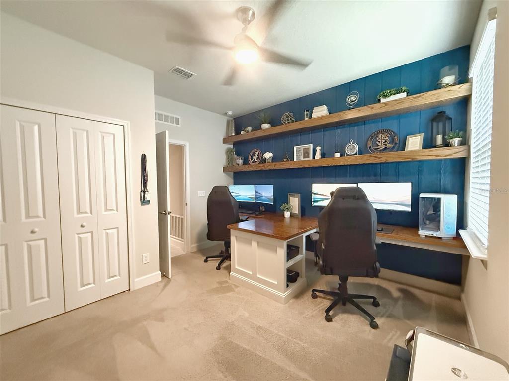 3181 Hill Point Street Minneola, FL 34715 - Photo 39 of 52 a view of a workspace with furniture and a window