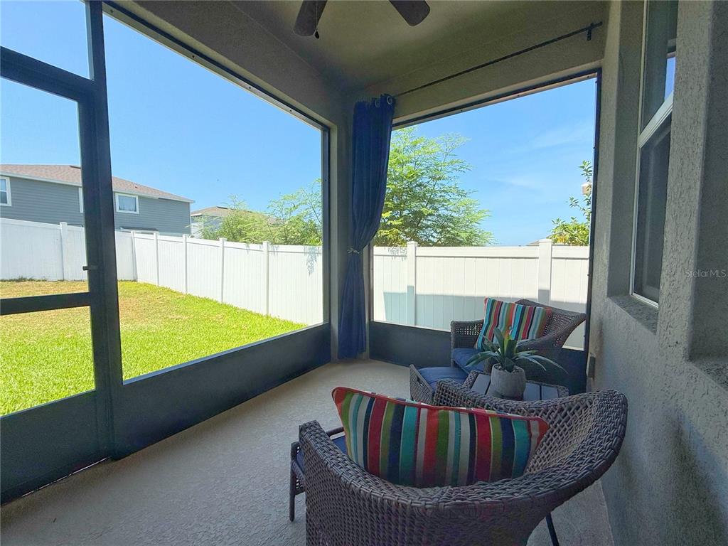 3181 Hill Point Street Minneola, FL 34715 - Photo 43 of 52 a living room with furniture and a large window