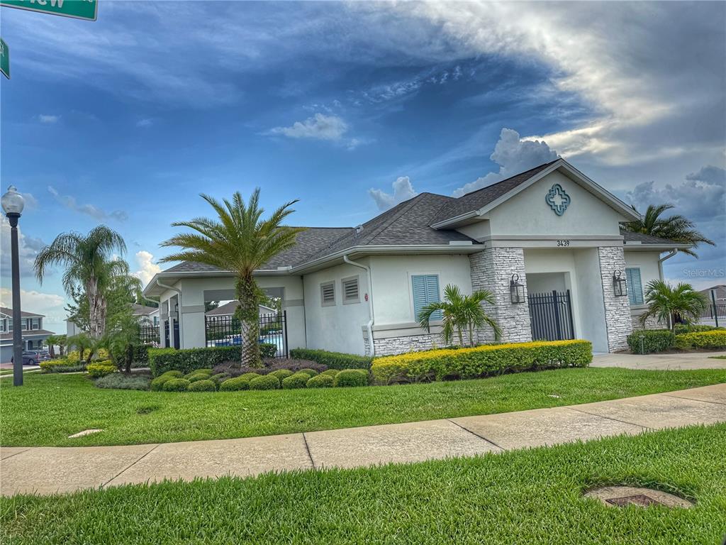 3181 Hill Point Street Minneola, FL 34715 - Photo 47 of 52 a front view of a house with a garden and plants